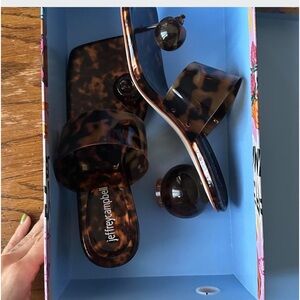 Jeffrey Campbell Latus Tortus brown and tan leopard print slides.
